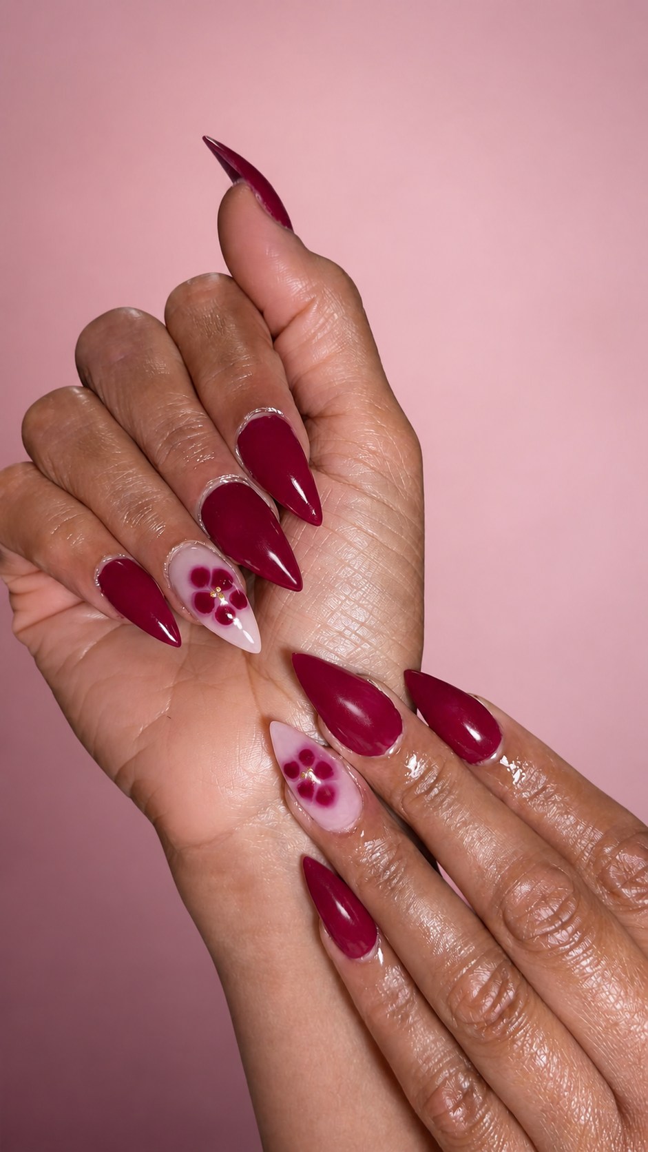 Deep berry almond nails with pink floral accents